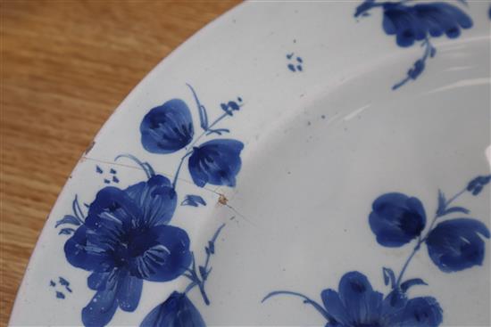 An 18th century Glasgow Delftware charger and a matching plate, largest 35.5cm